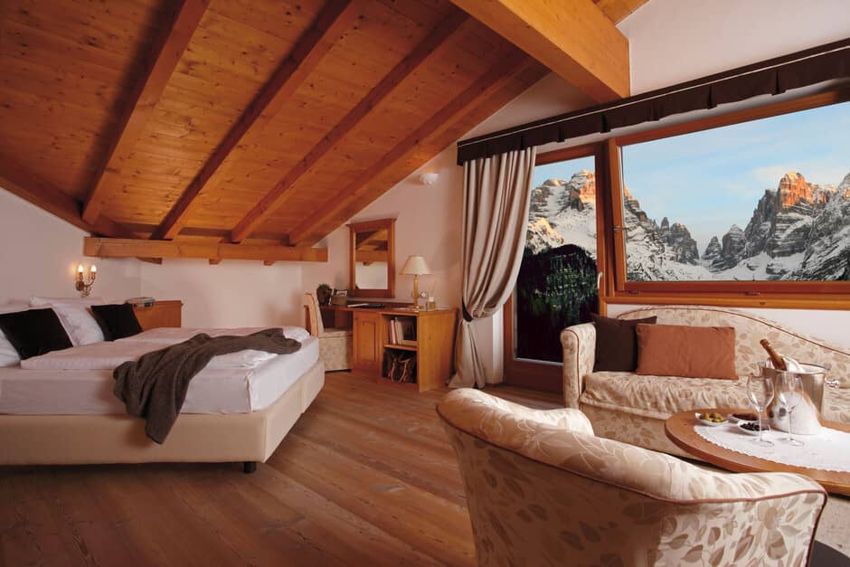 Attic bedroom with mountain-view seating area and built-in desk