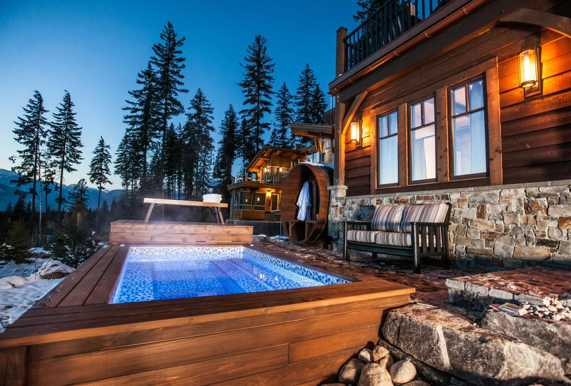 Heated outdoor plunge pool and barrel sauna with mountain views
