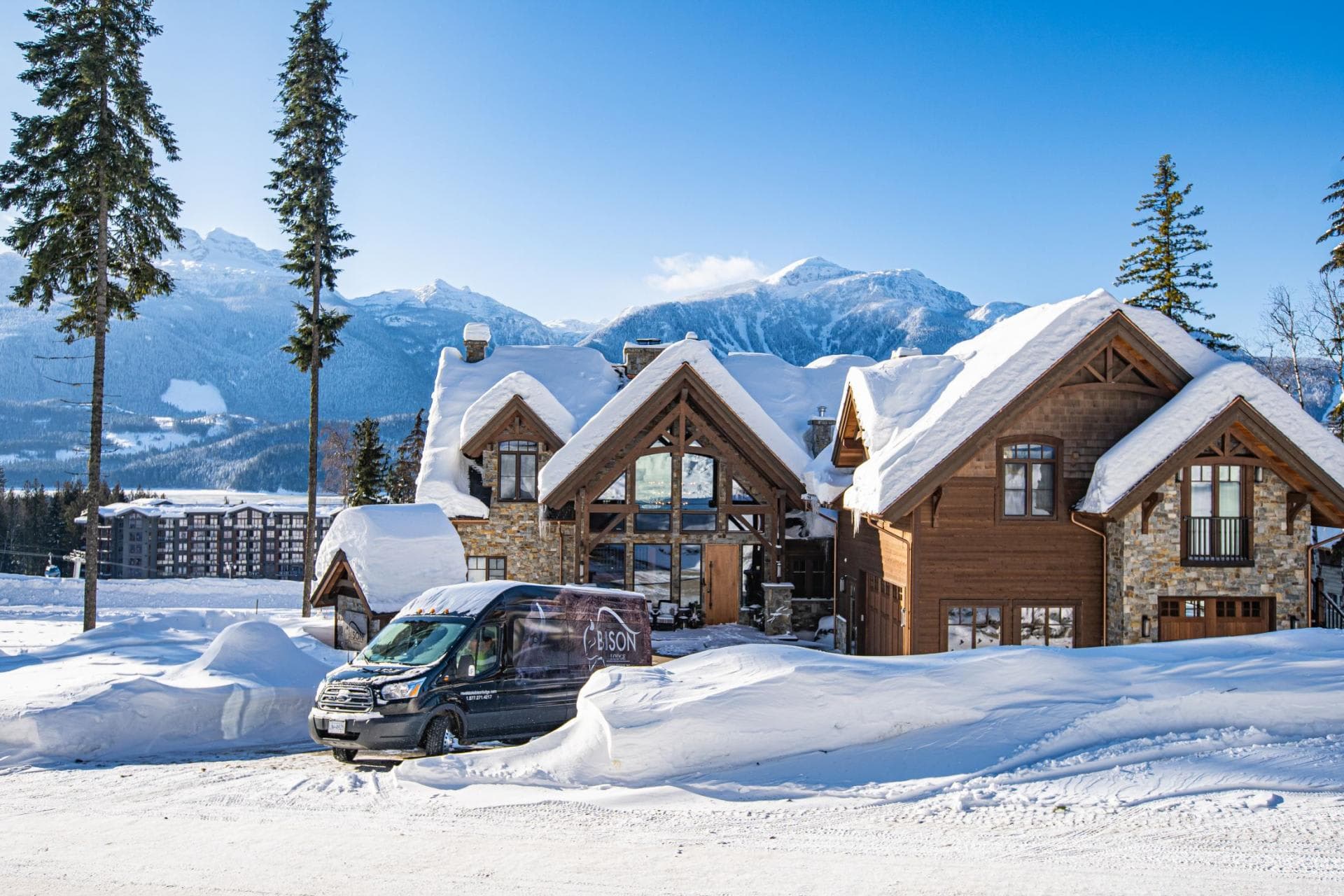 Timber-frame lodge exterior with mountain views and private shuttle service