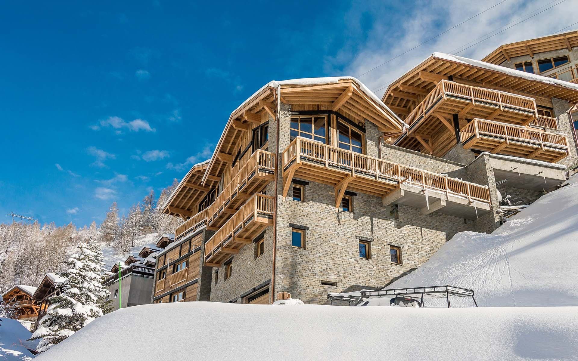 Ski-in/ski-out chalet with stone facade and private wrap-around balconies