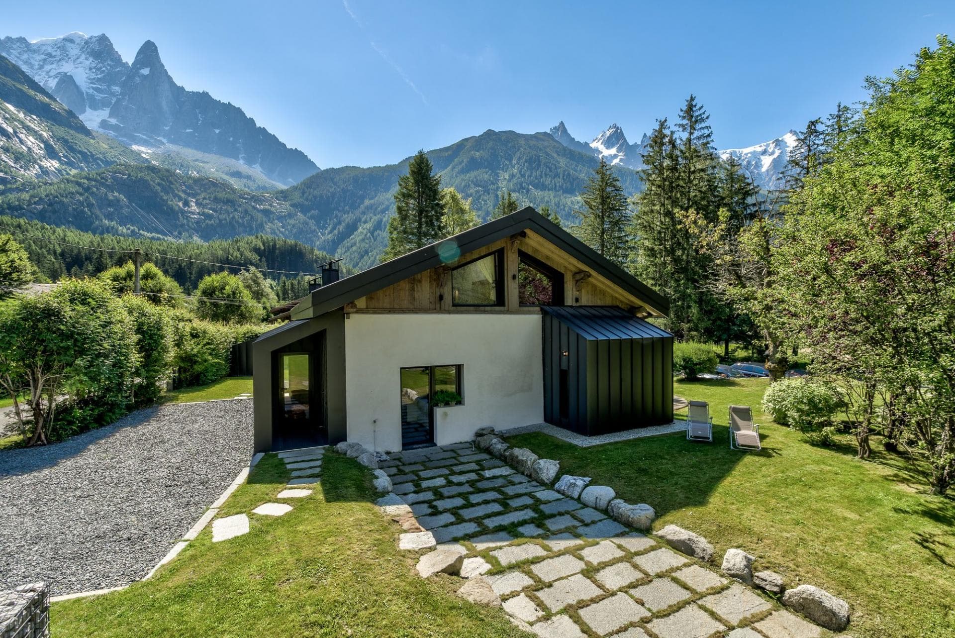 Chalet exterior with private lawn and mountain views