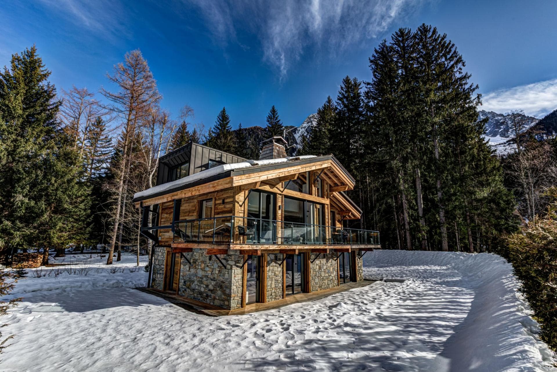 Ski-in chalet with wrap-around balcony and stone foundation