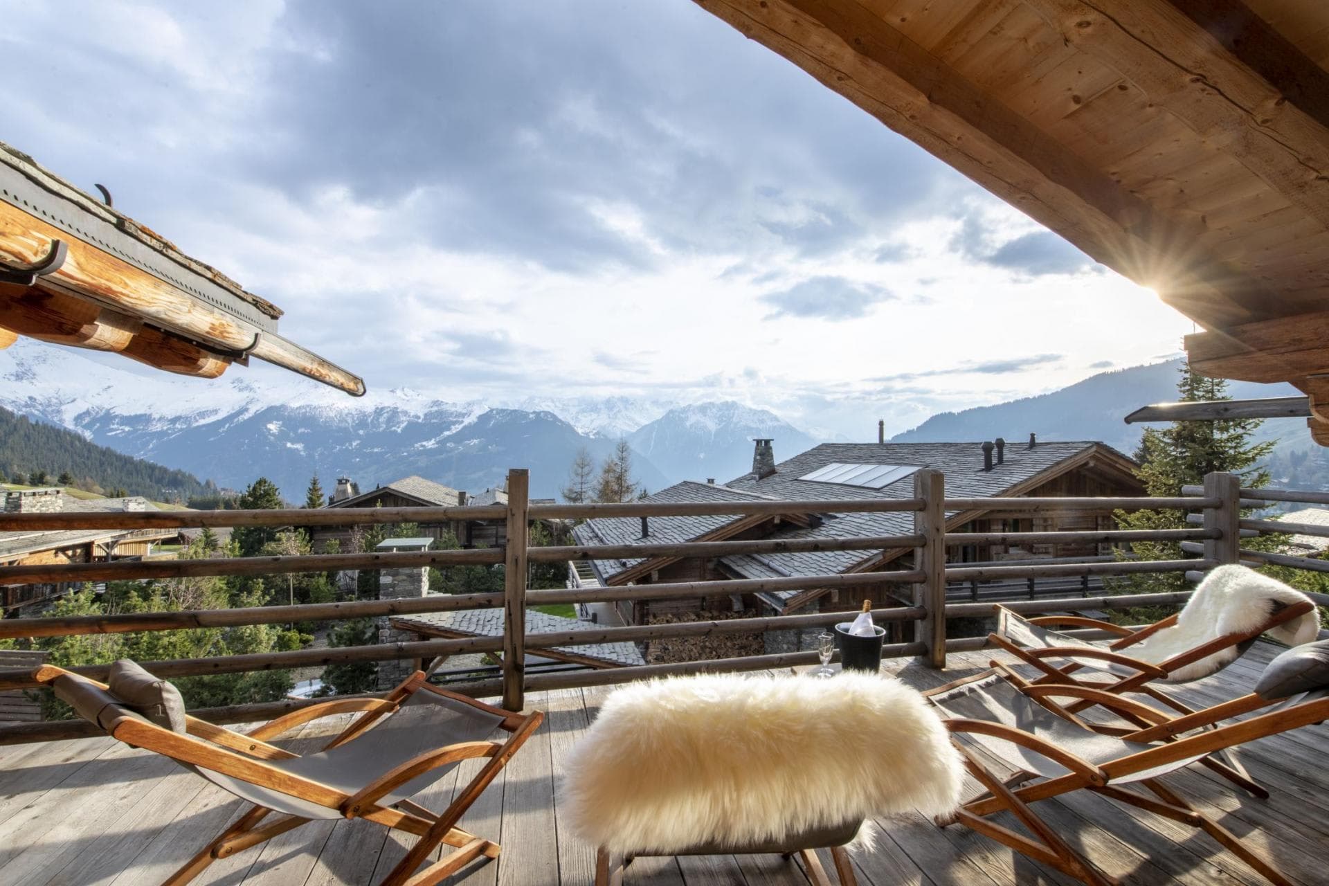 Timber balcony with wooden lounge chairs and mountain views