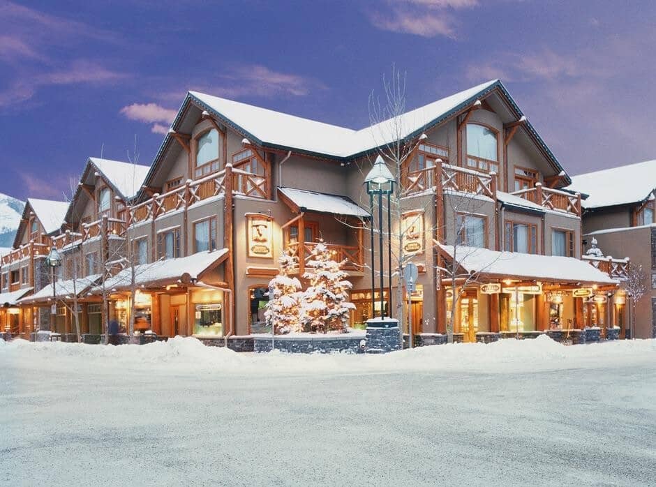 Ski-in/ski-out lodge exterior with street-level retail and private balconies