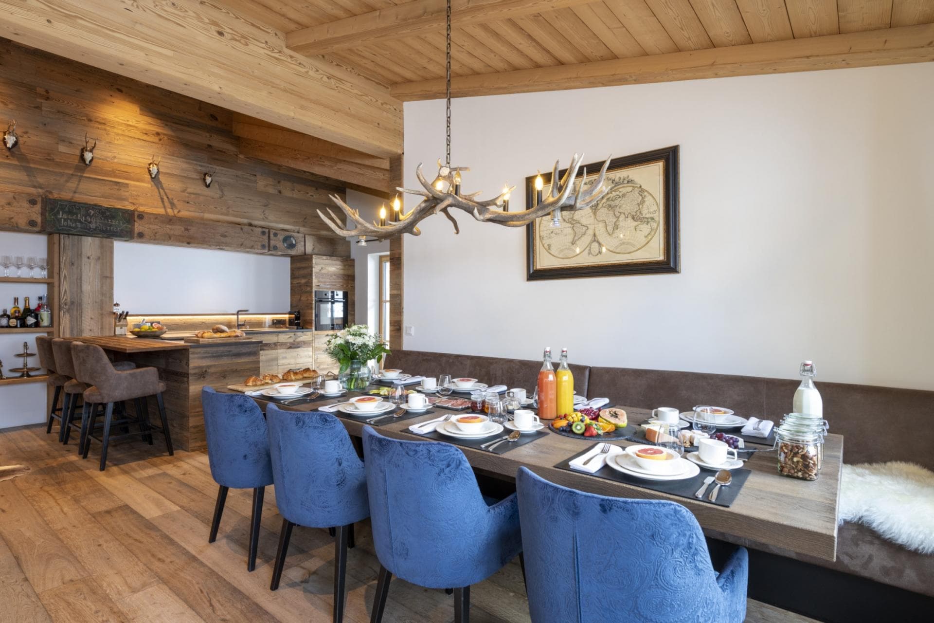 Dining area seats 8; antler chandelier and built-in bench seating