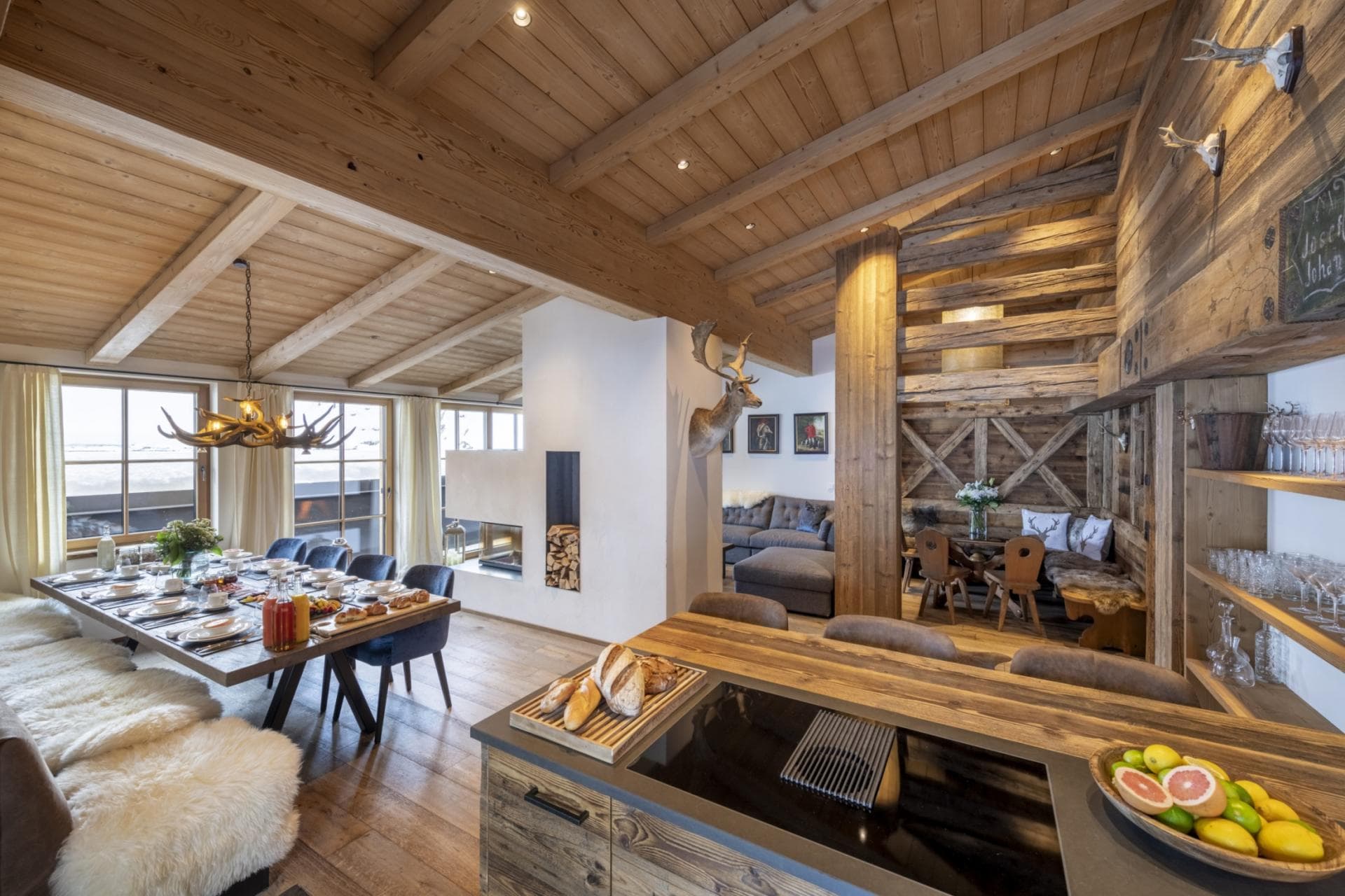 Open-plan living with chef's kitchen, dining for 8, exposed beams, and valley views