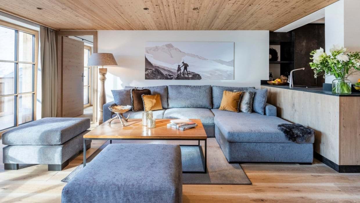 Living area with large sectional seating and floor-to-ceiling balcony doors