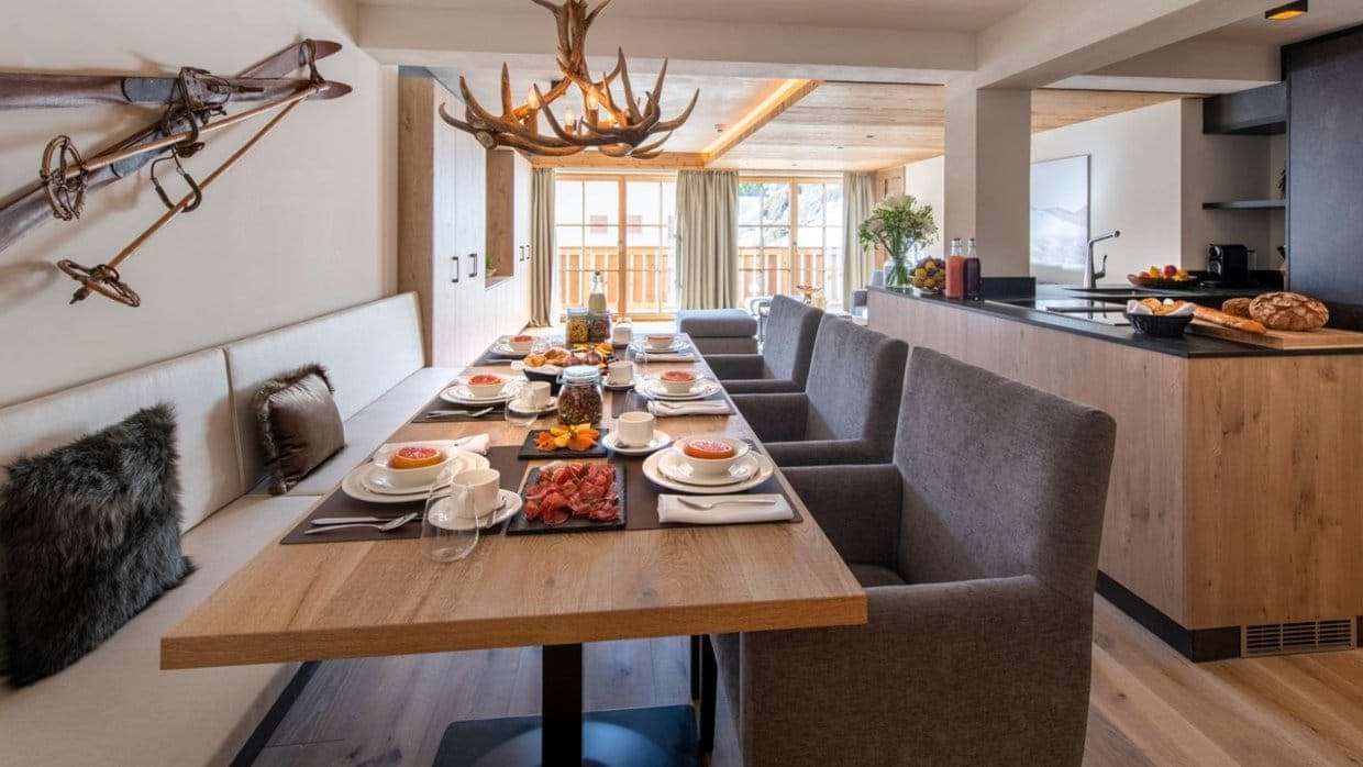 Dining area seats 8 with banquette seating and mountain views