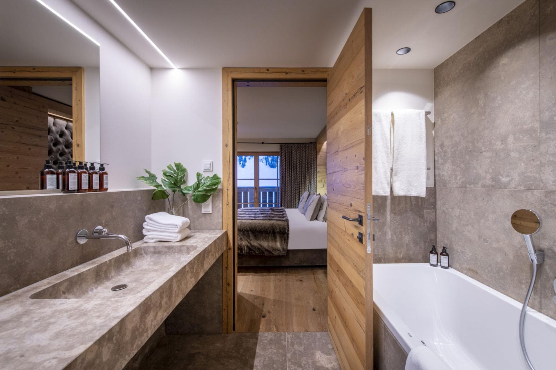 En suite bathroom with stone vanity and soaking tub