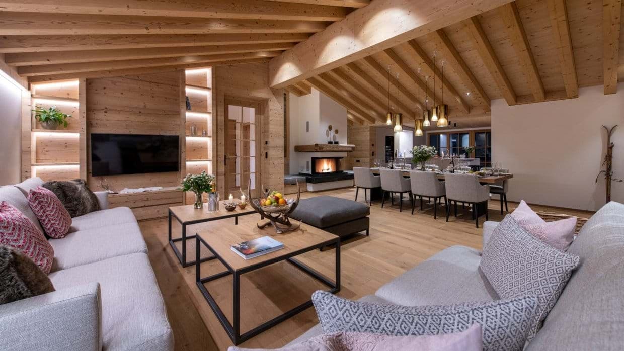 Open-plan living area with wood-burning fireplace and dining seating for 10