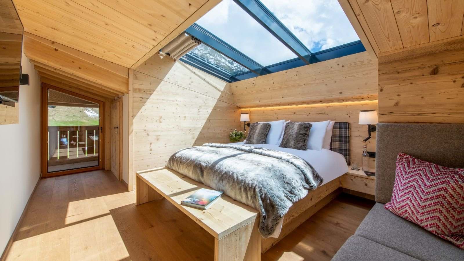Attic bedroom with retractable glass ceiling and balcony access
