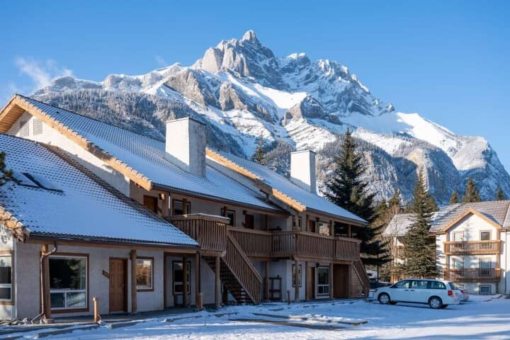 Ski resort exterior with private balconies and mountain peak views