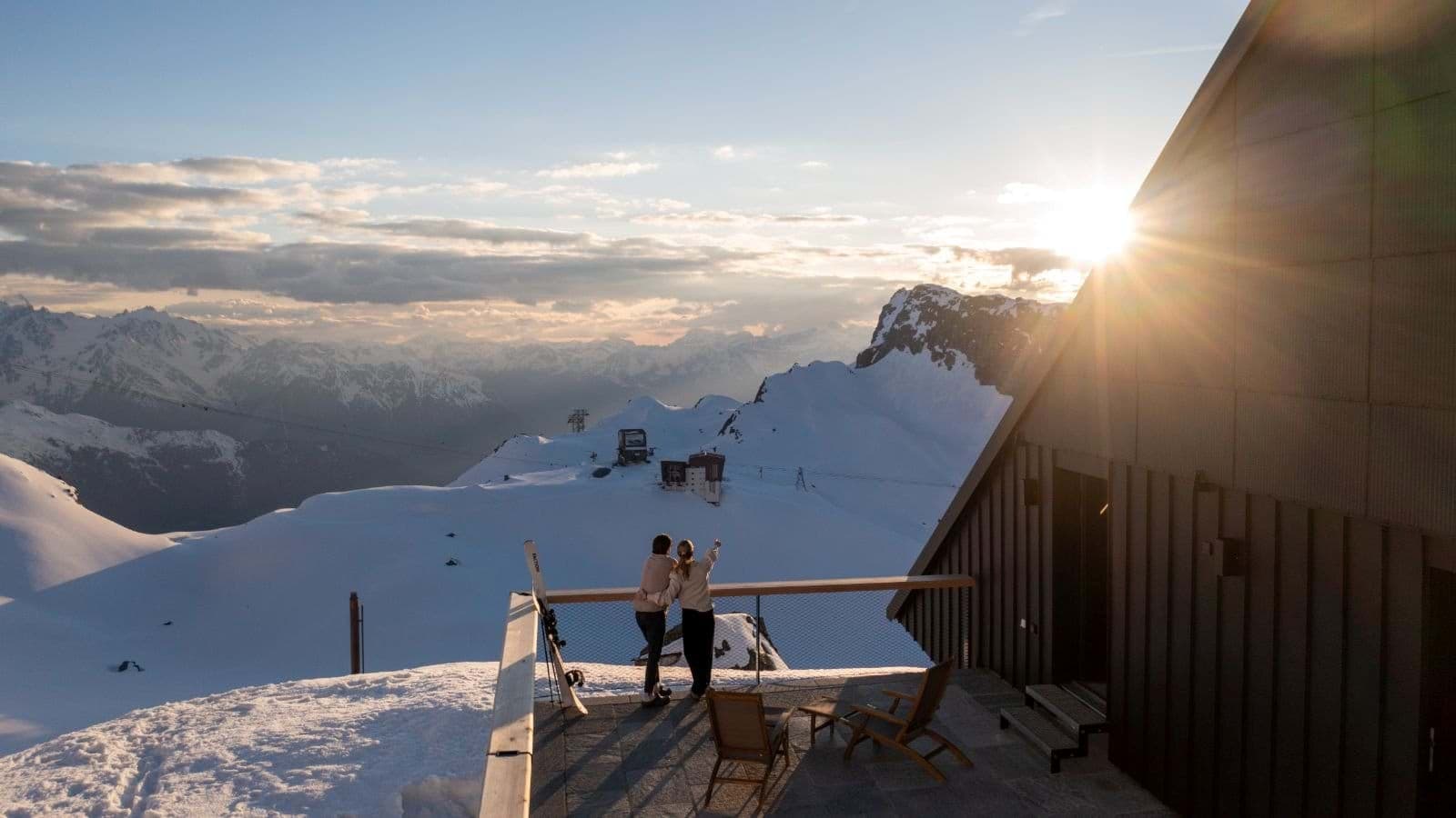 Private terrace with lounge chairs and panoramic mountain sunset views
