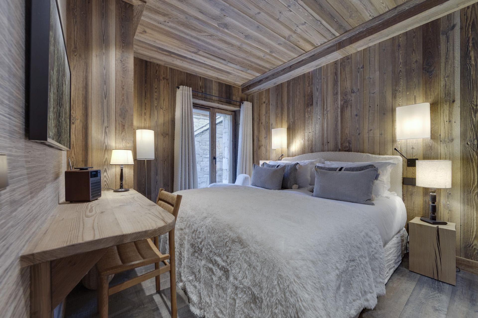 Guest bedroom with king bed, reclaimed wood walls, and workspace