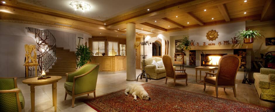 Lobby lounge with wood-burning fireplace and spiral staircase access