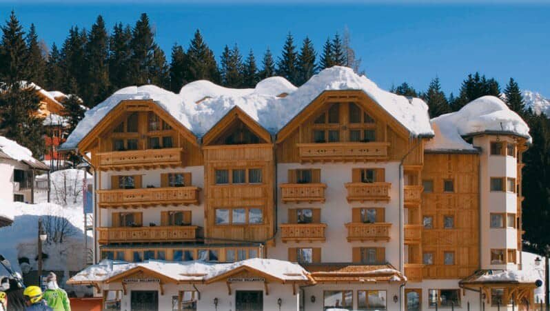 Ski-in/ski-out chalet with private balconies and mountain forest backdrop
