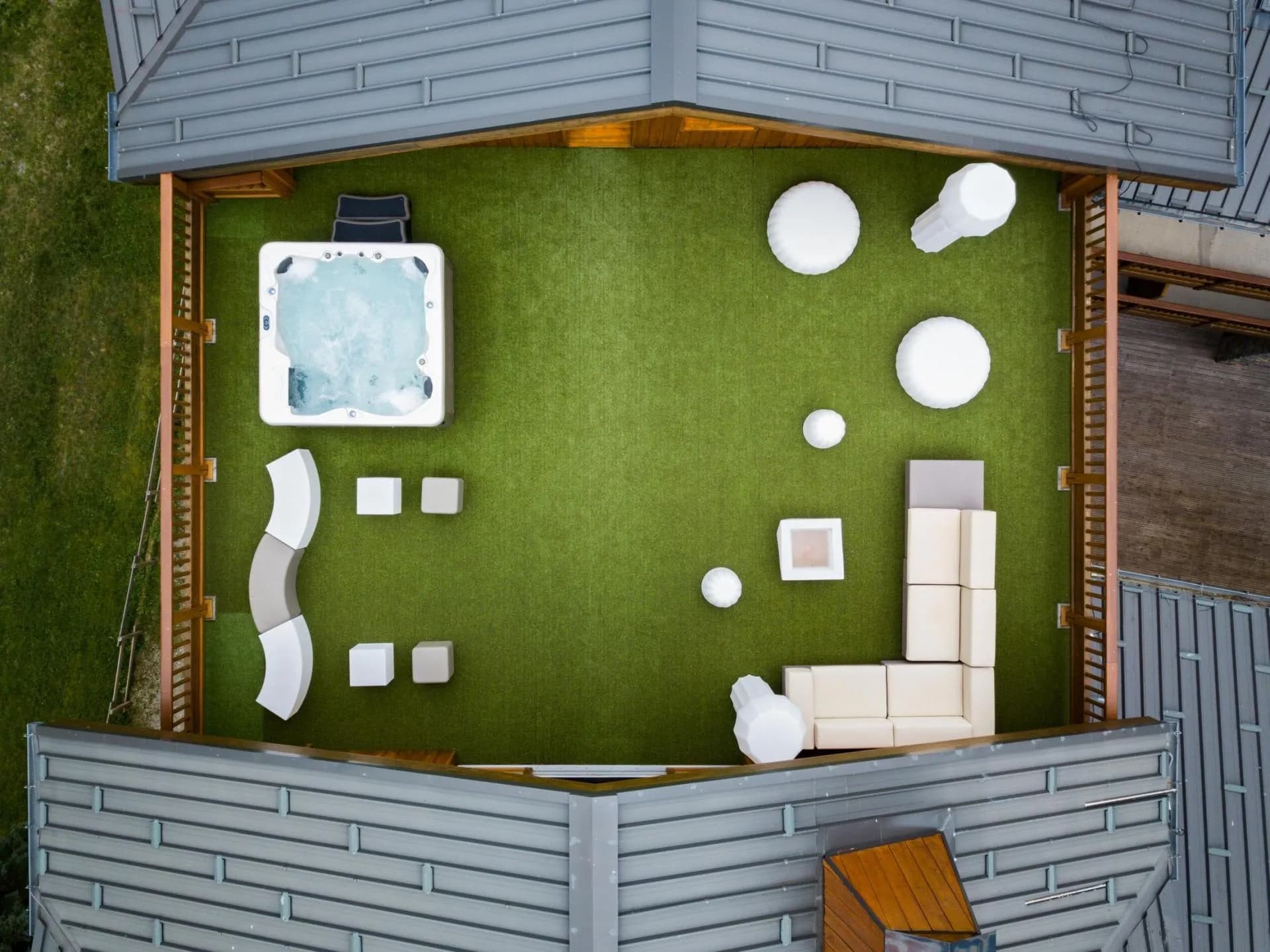 Rooftop terrace with artificial turf, hot tub, and lounge seating