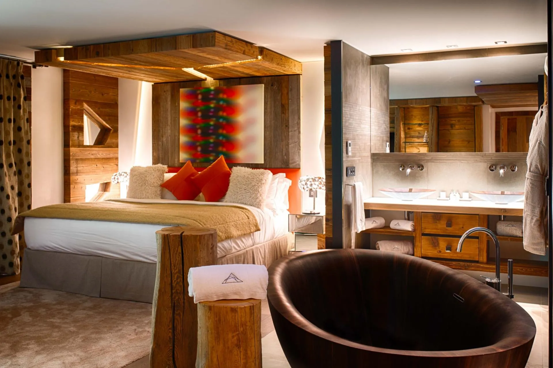 Primary bedroom suite with king bed and deep wooden soaking tub