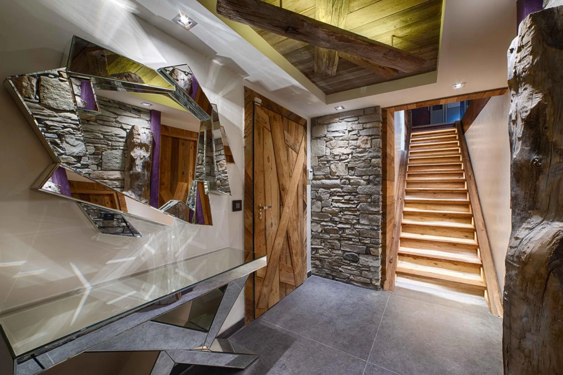 Entryway with reclaimed wood accents and backlit wooden staircase