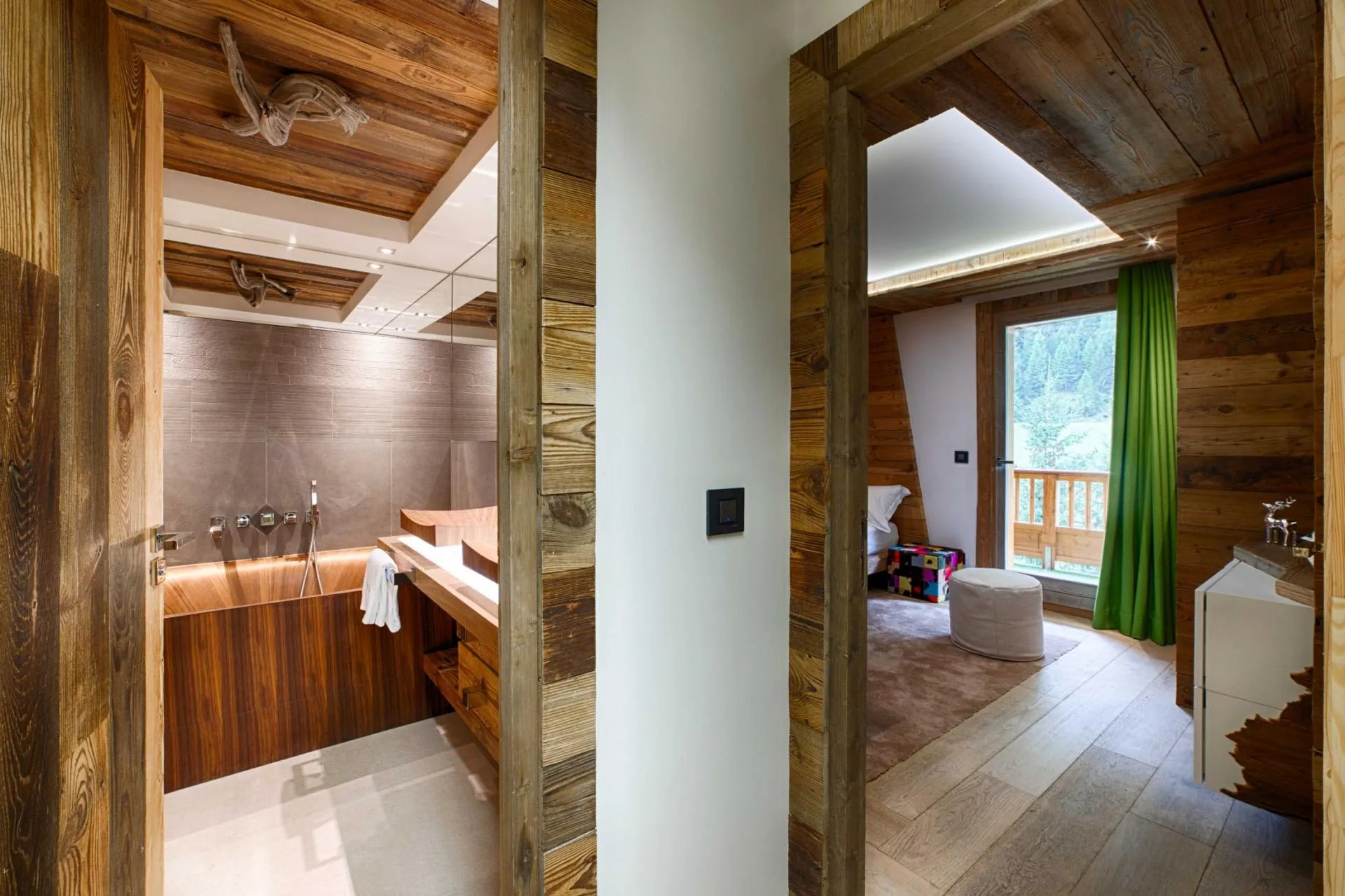 En suite bathroom with wooden soaking tub and bedroom with balcony access
