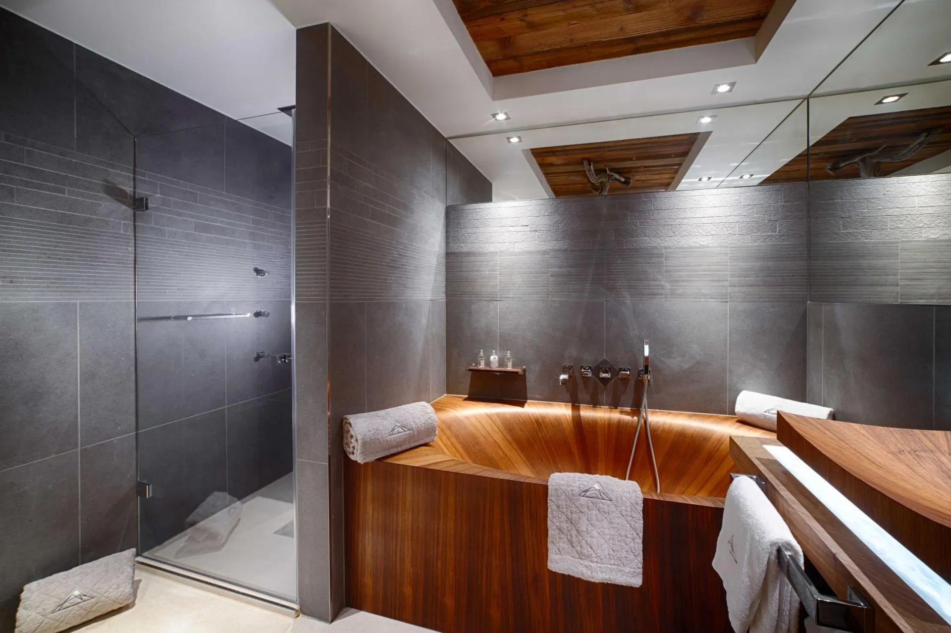 Bathroom with wooden soaking tub and walk-in shower with body jets