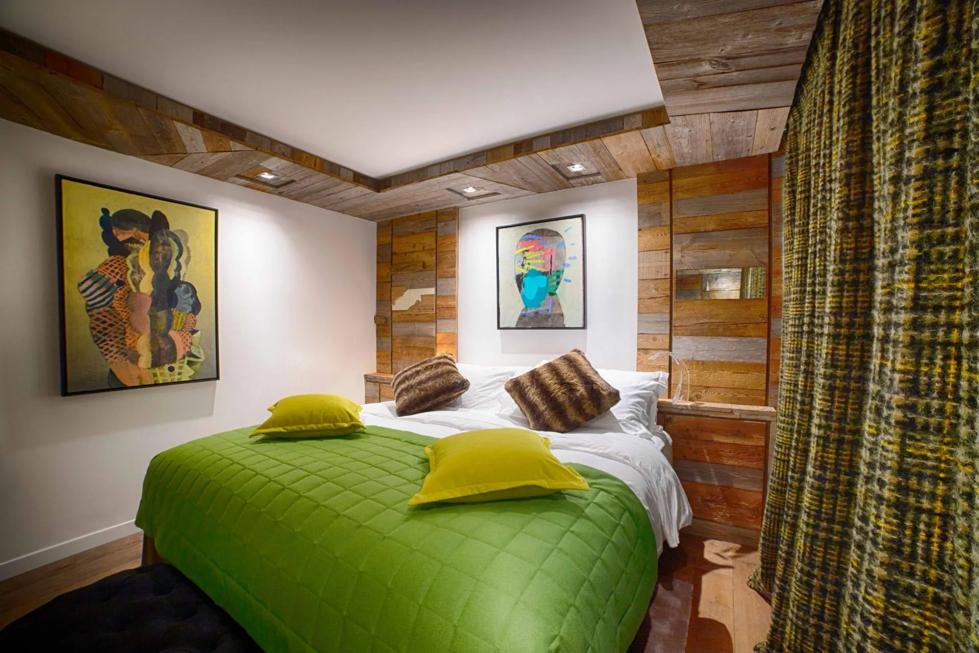 Bedroom with king bed and reclaimed wood wall paneling