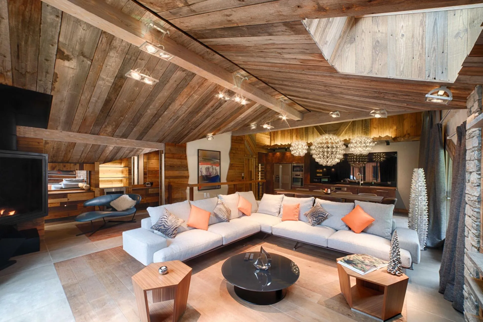 Living room with wood-burning fireplace and vaulted reclaimed wood ceilings