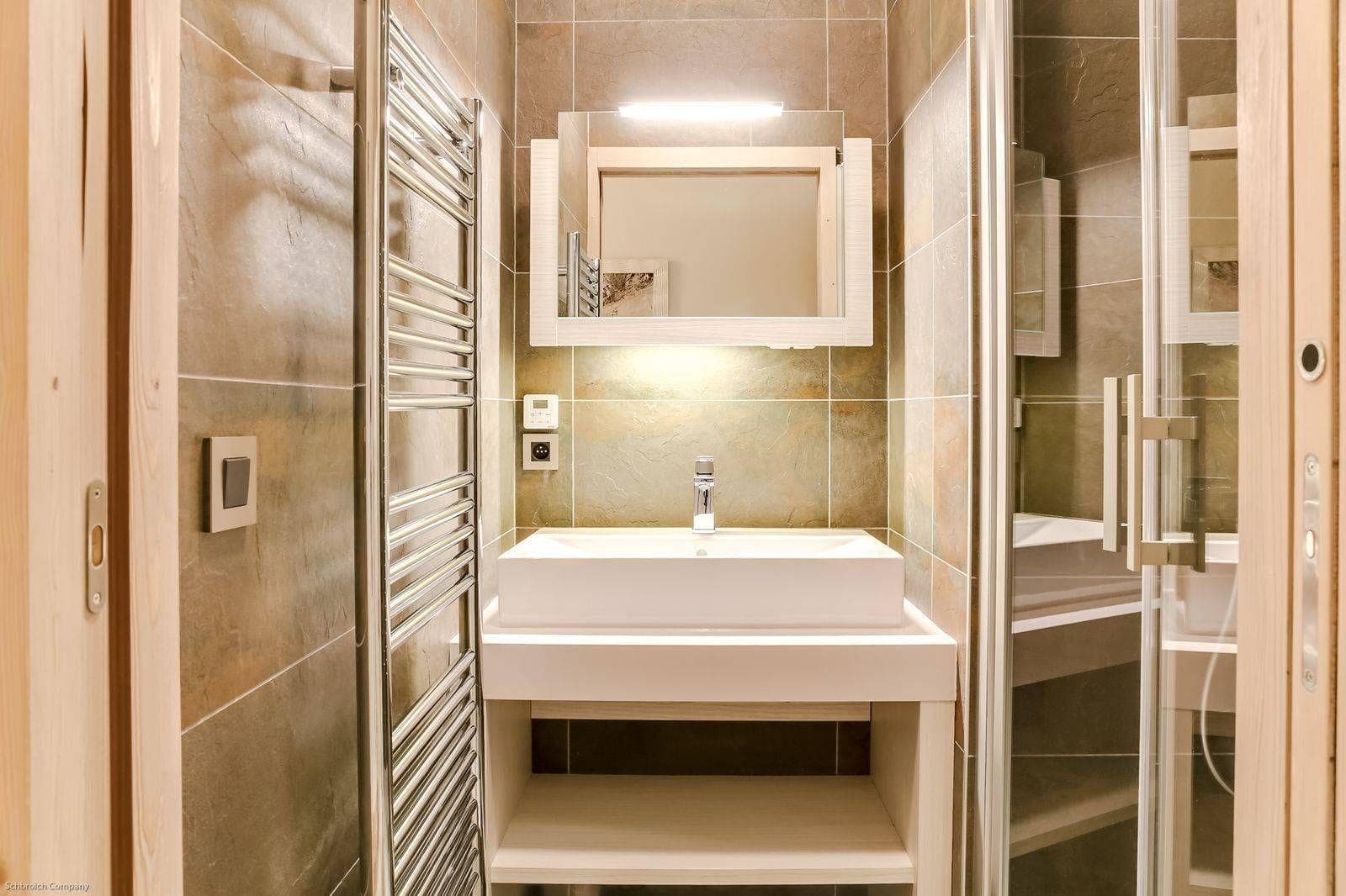 Bathroom featuring walk-in shower and wall-mounted heated towel rail