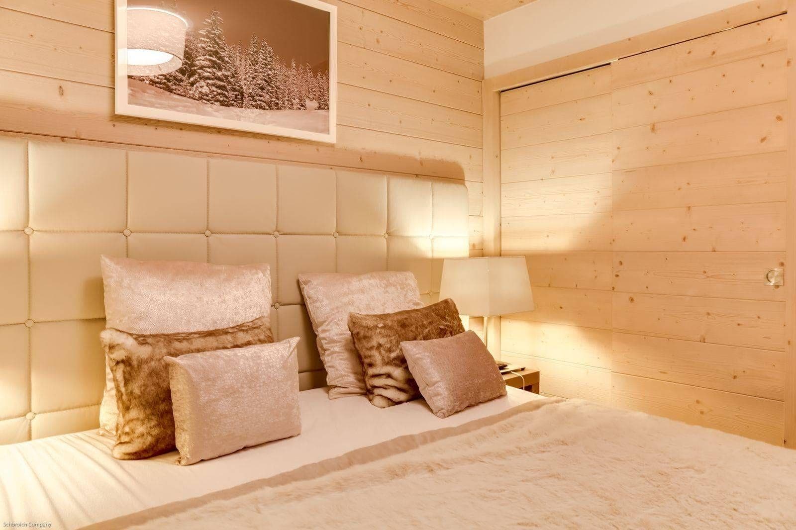 Guest bedroom with wood paneling and large sliding closet