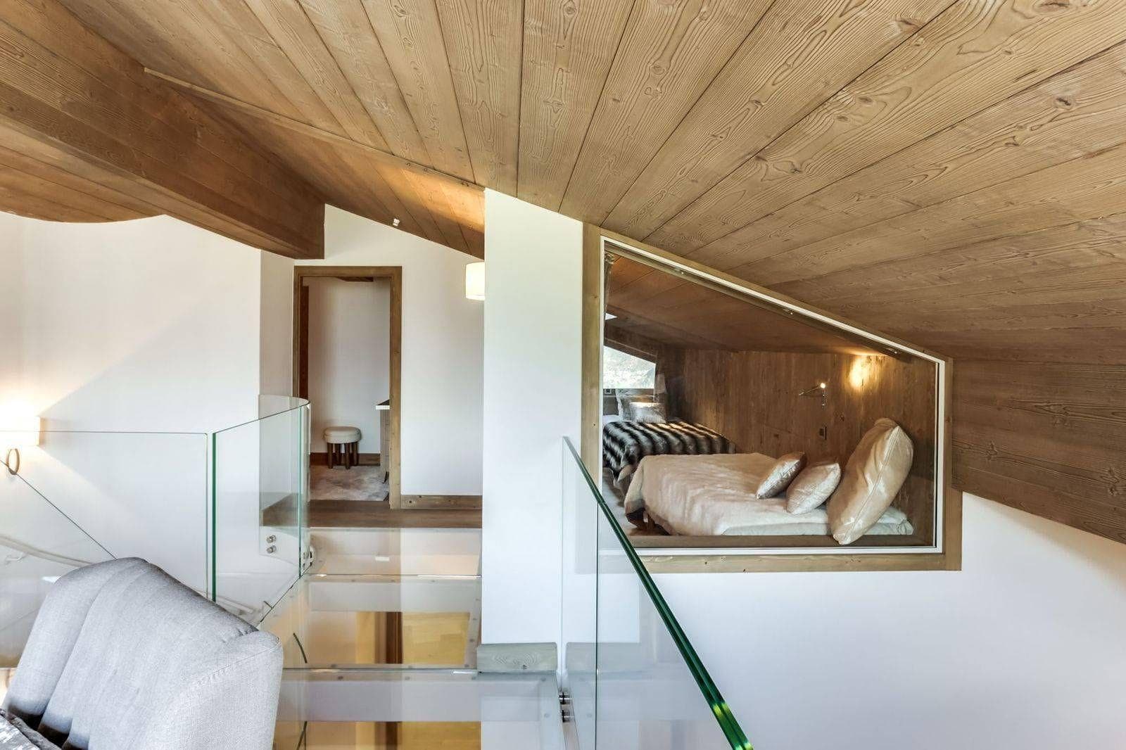 Mezzanine hallway with glass floor overlooking the living area