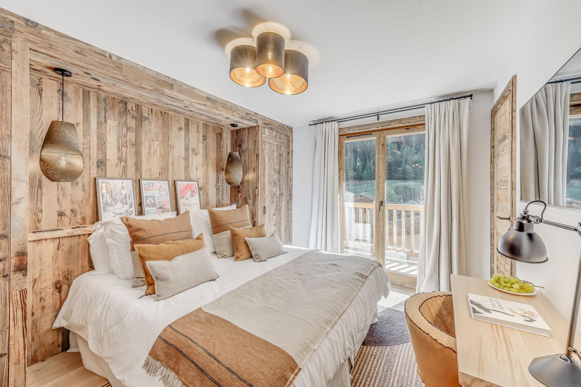Bedroom with king bed, reclaimed wood walls, and private balcony access