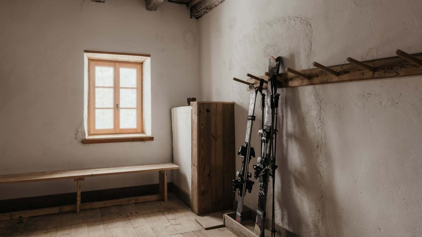 Ski storage room with wall-mounted racks and bench seating