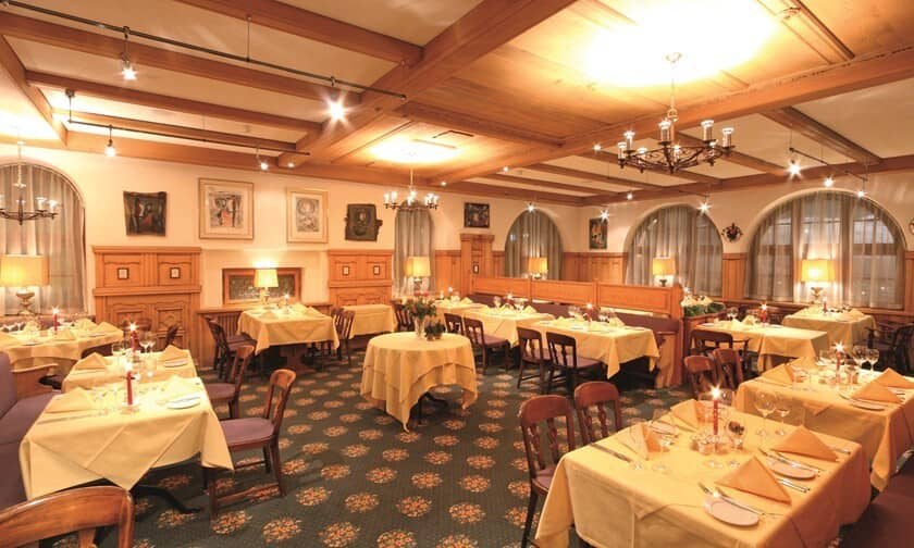Dining room with traditional wood paneling and exposed beam ceiling