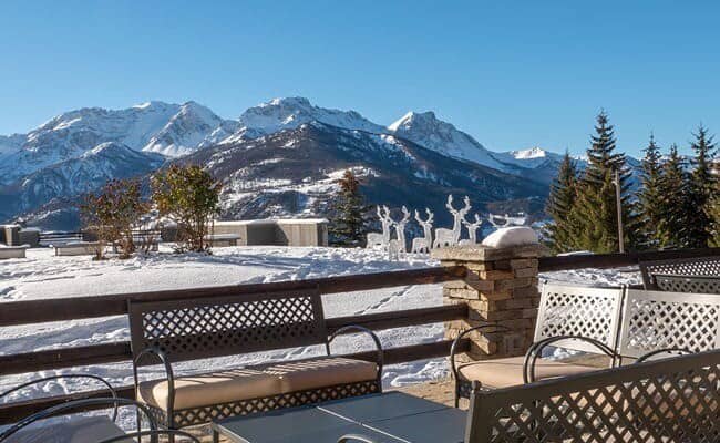 Stone patio with mountain views and outdoor seating