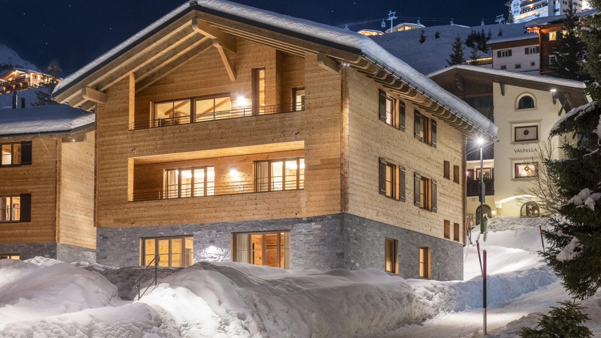 Ski-in/ski-out chalet with timber facade and private balconies overlooking slopes