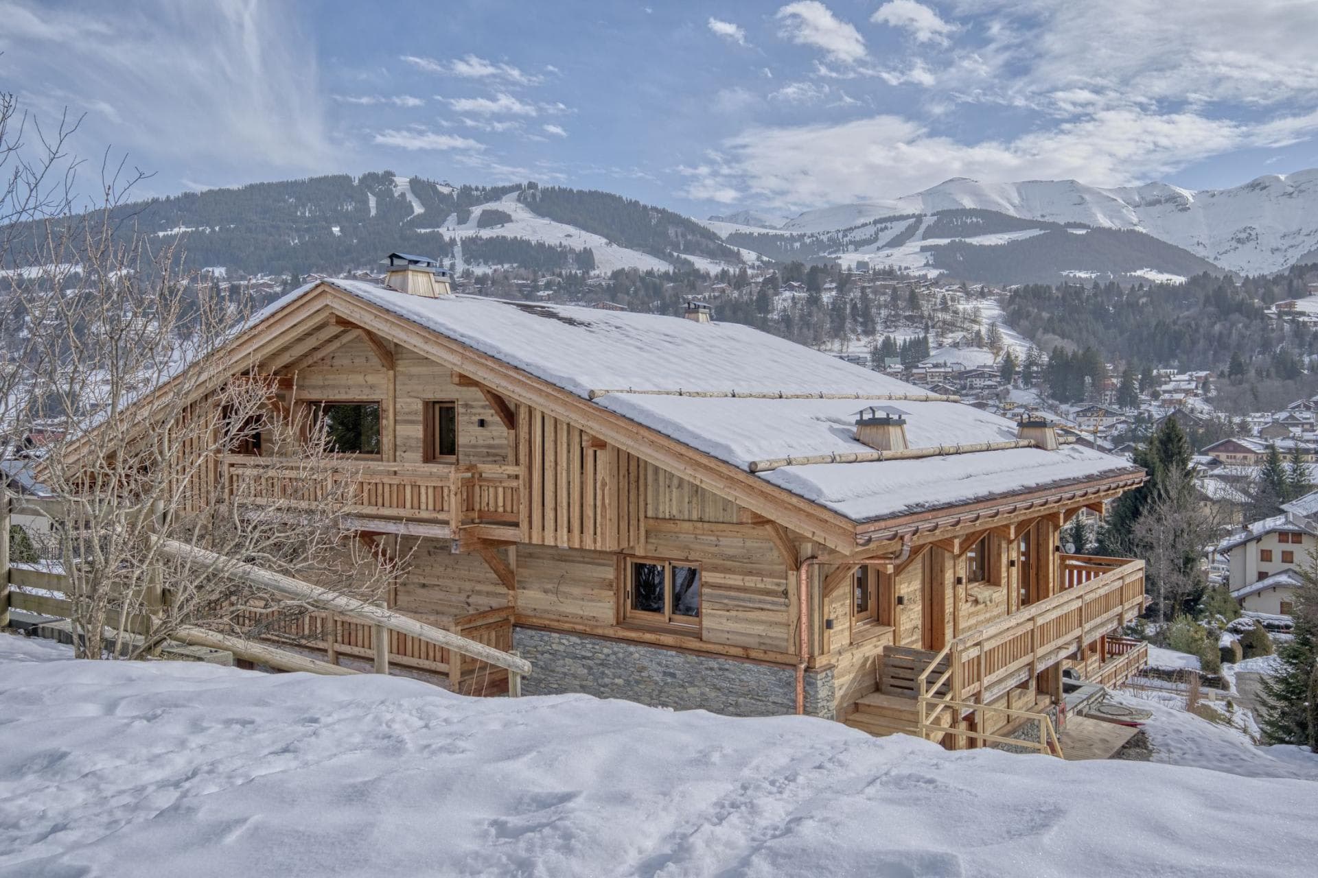 Ski-in chalet exterior with wraparound balconies and mountain views