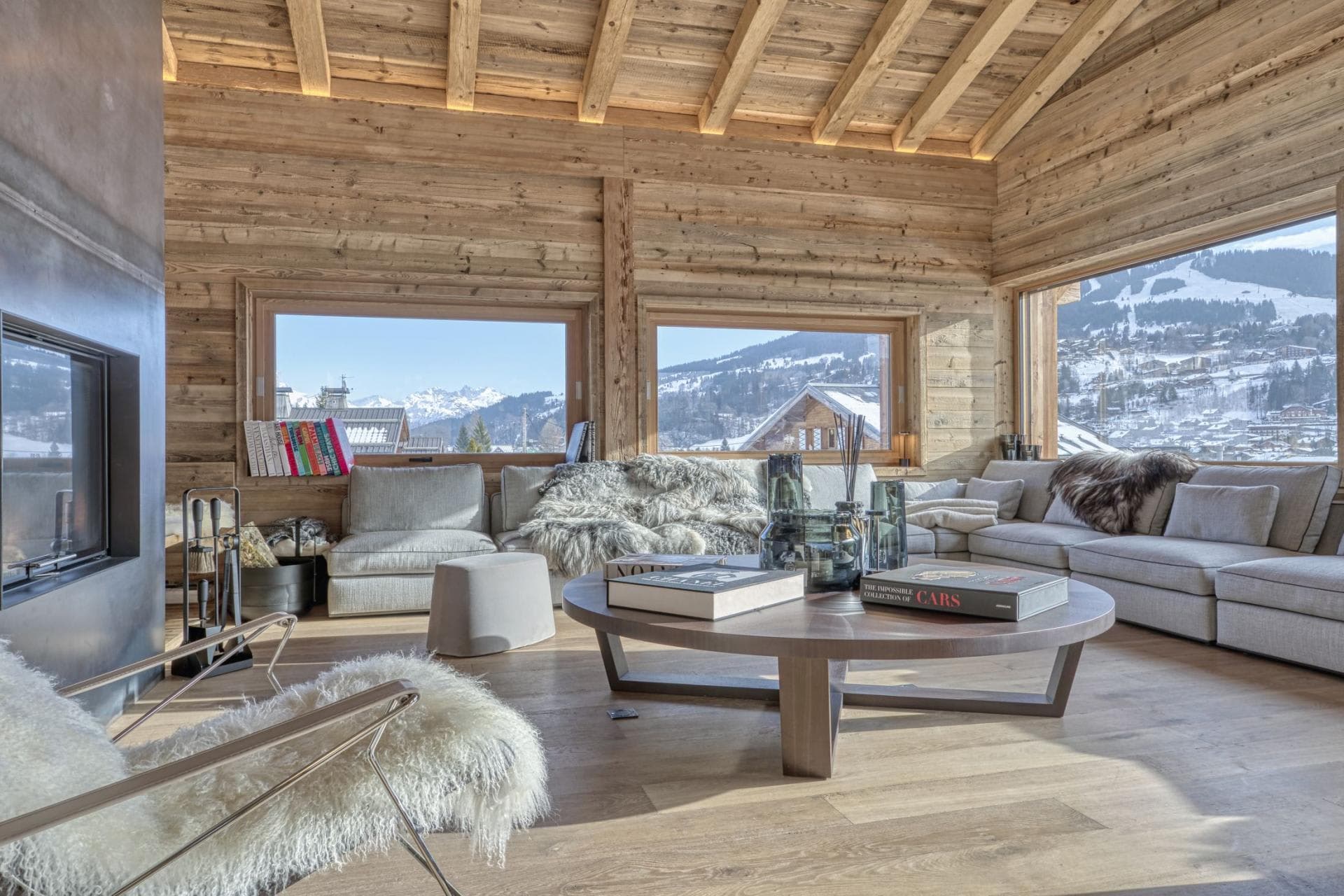 Living area with wood-burning fireplace and panoramic ski slope views