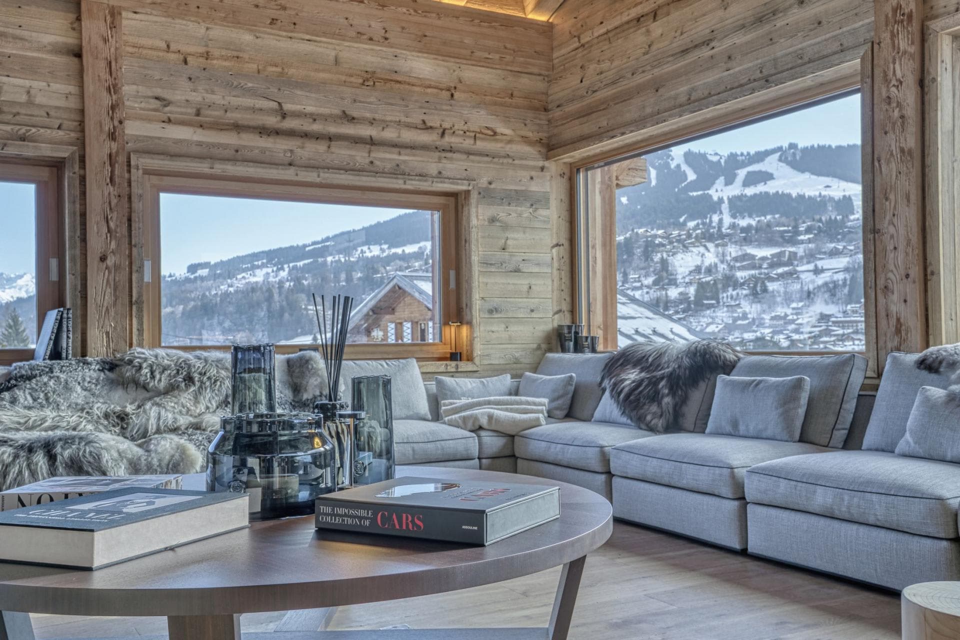 Living area with corner sectional and panoramic ski resort views