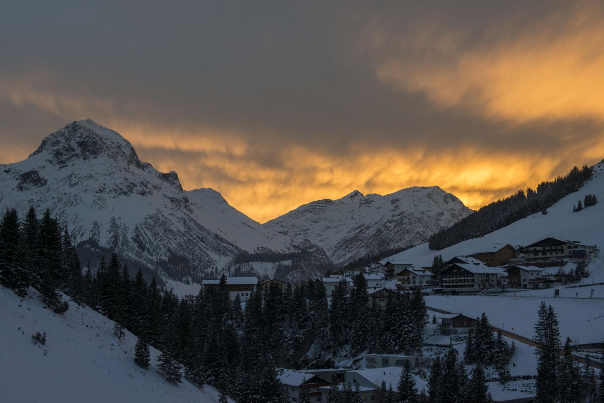 Ski-in, ski-out village view with sunset over mountain peaks