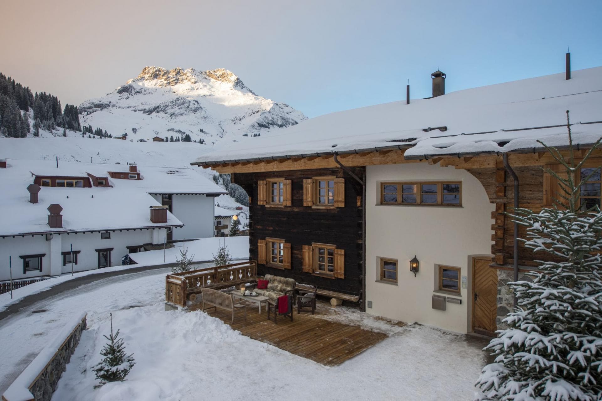 Chalet exterior with timber terrace and direct alpine views