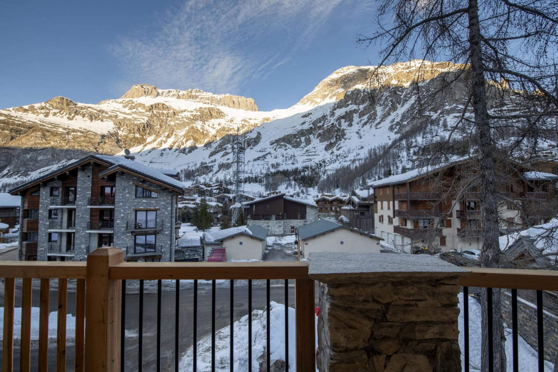Private balcony overlooking alpine village and mountain peaks