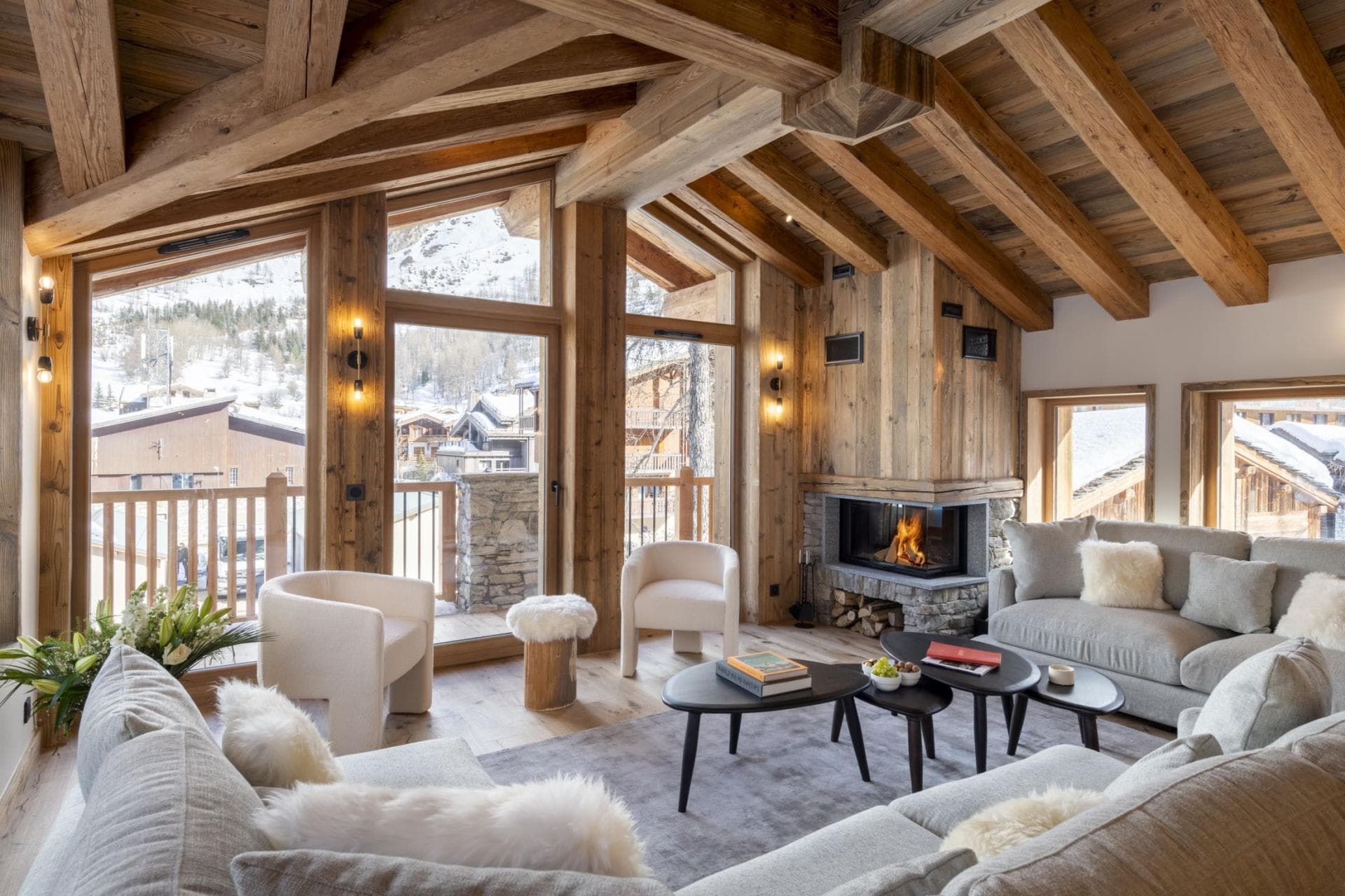 Living room with wood-burning fireplace and mountain-view balcony access