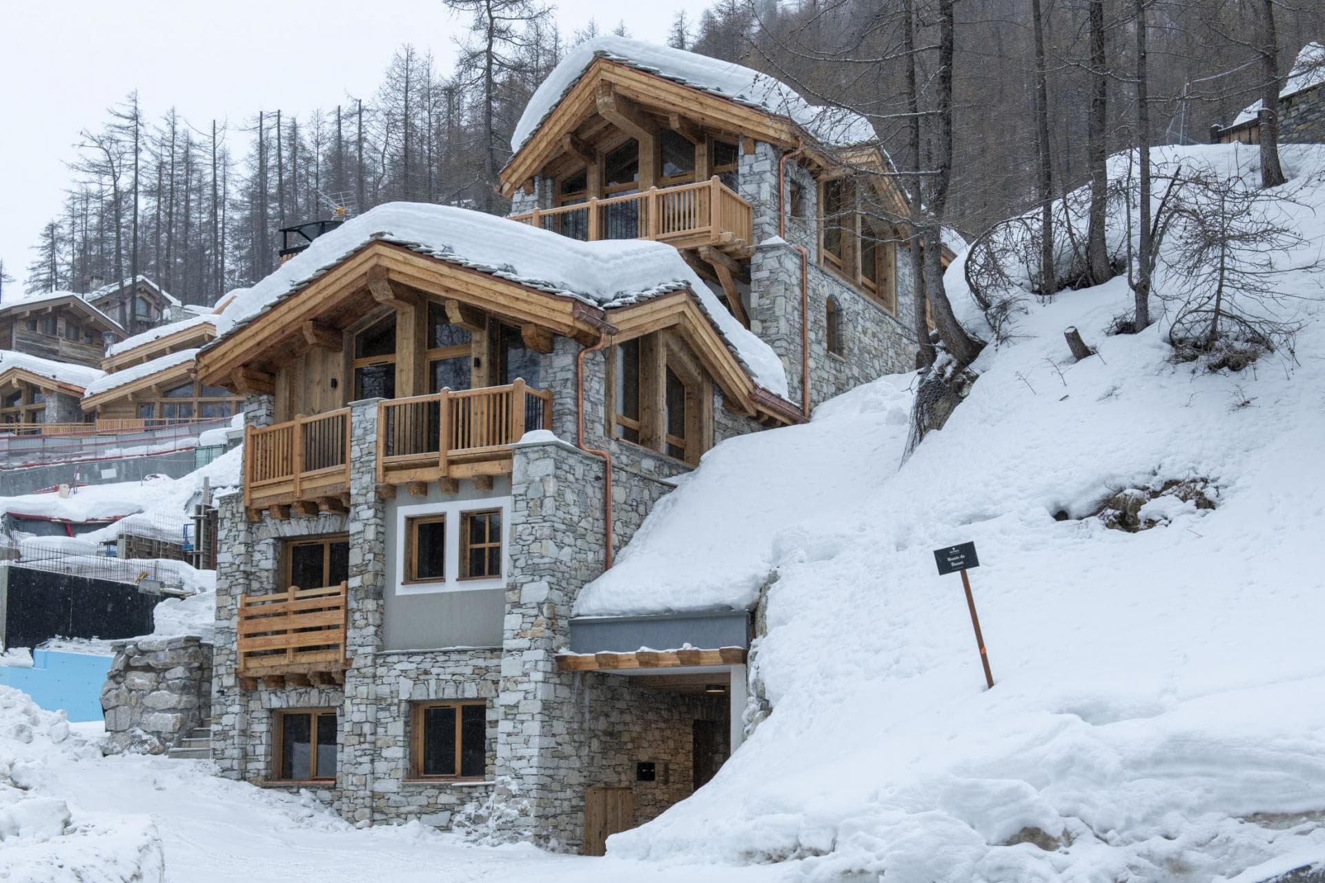 Ski-in, ski-out chalet exterior with private balconies and stone masonry