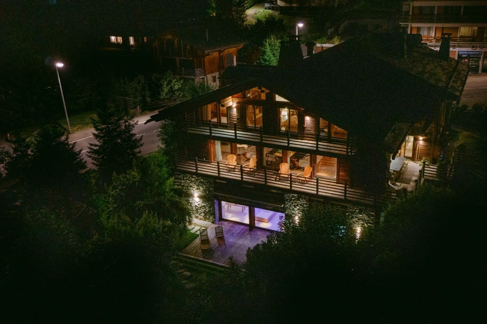 Chalet exterior with three levels of decking and lower-level indoor pool