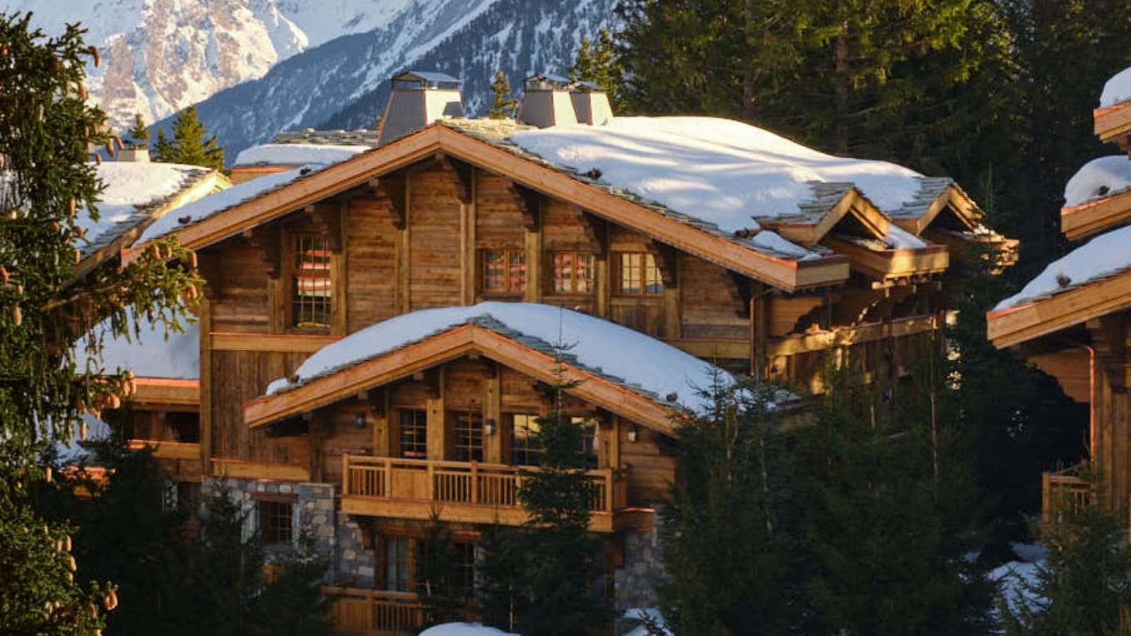 Ski-in chalet exterior with private balcony and alpine mountain views