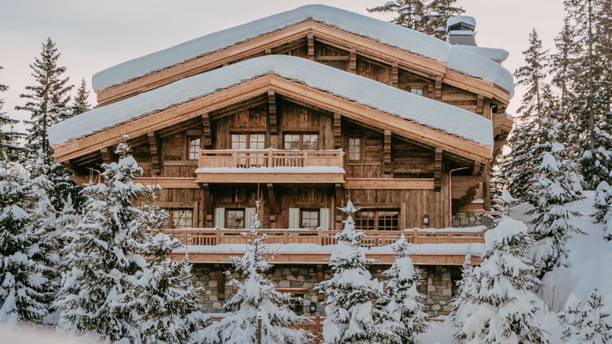 Ski-in ski-out timber chalet featuring multi-level wrap-around balconies