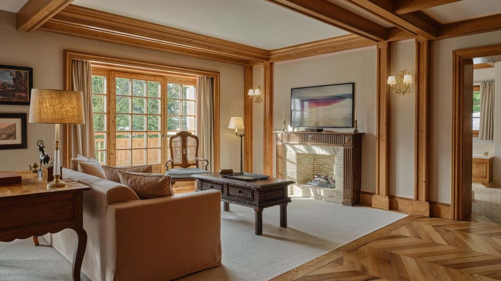 Living room with stone fireplace and balcony access