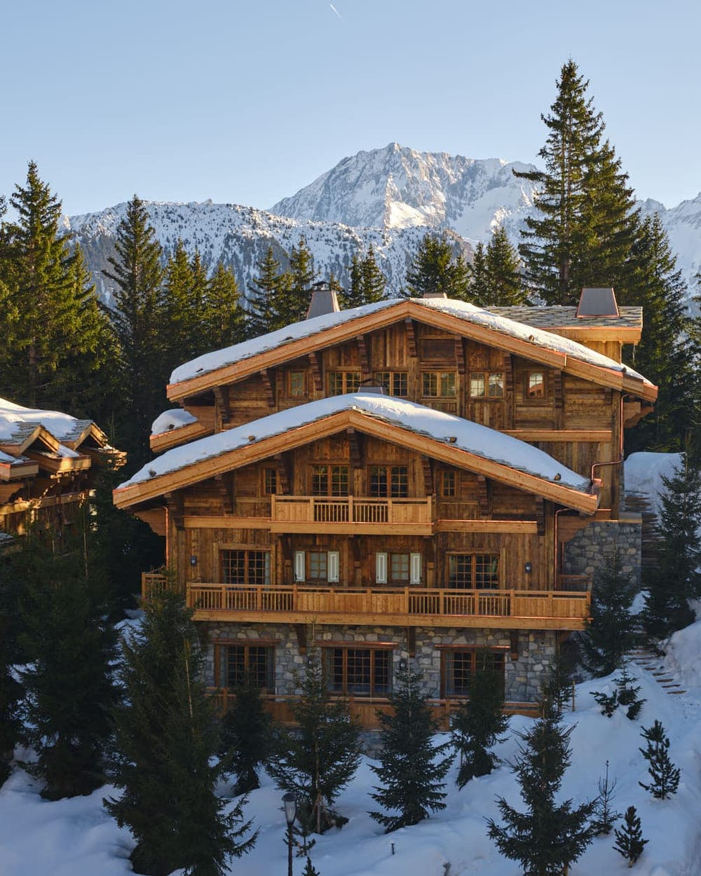 Timber chalet with three levels of balconies and mountain views
