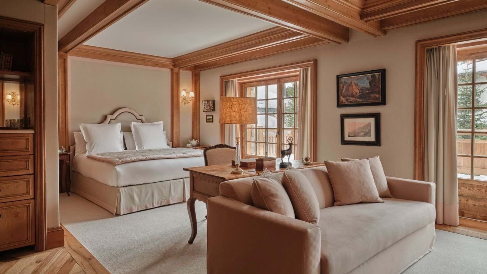 Primary bedroom with king bed, sitting area, and balcony access