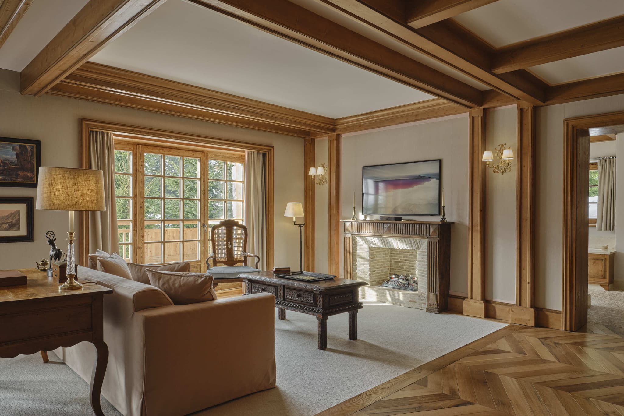 Living area with wood-burning fireplace and private balcony access